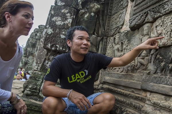  A G Adventures CEO [chief experience officer) with a traveller at the Siem Reap temple in Siem Reap, Cambodia.