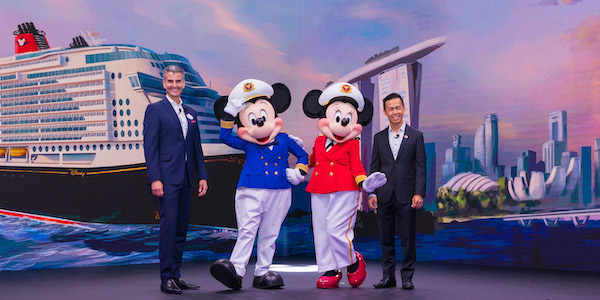 Disney Parks, Experiences and Products chairman Josh D’Amaro (left) and Singapore Tourism Board chief executive Keith Tan celebrate with Captain Mickey Mouse and Captain Minnie Mouse during a joint news conference in Singapore. (Daryl Goh, photographer)