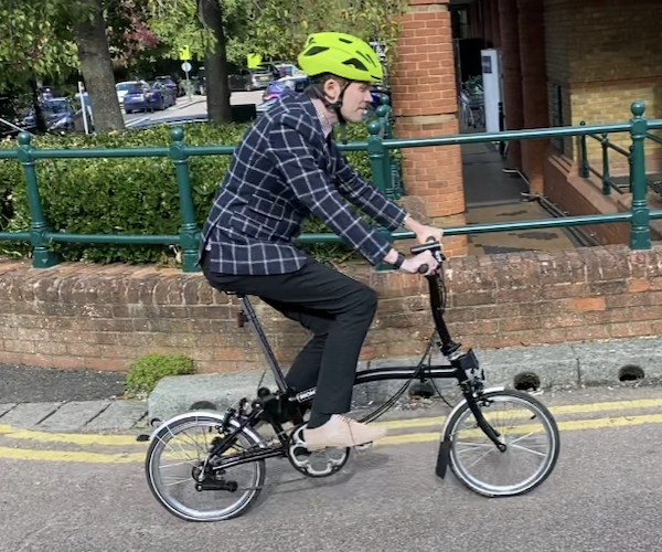 Ashley Quint of TravelTime World on his Brompton bike