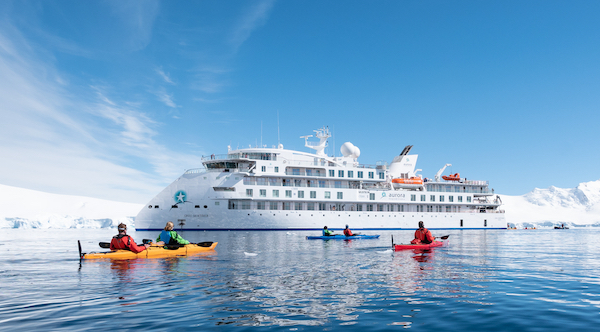 Kayaking by the Greg Mortimer, Port Lockroy, Antarctica. Picture by Al Bakker. 