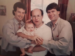 David Gambier with daughter Dani as a baby, with Gary Wardrope (left) and Lloyd Reynolds.